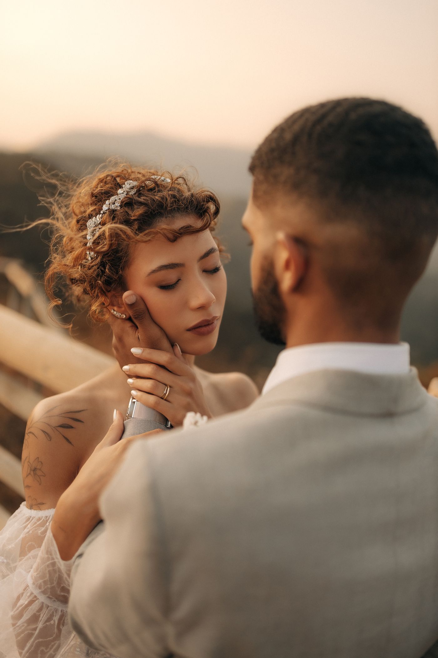 Wedding couple embracing outdoors at golden hour